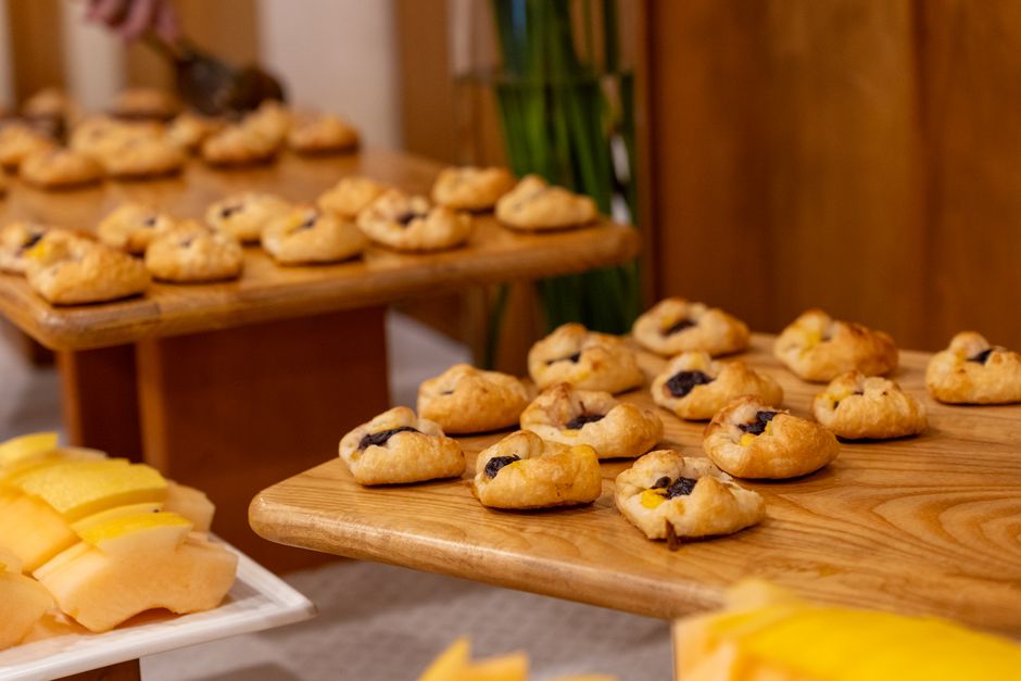 Close-up of beautifully arranged artisan pastries on wooden platters in a cozy setting.
