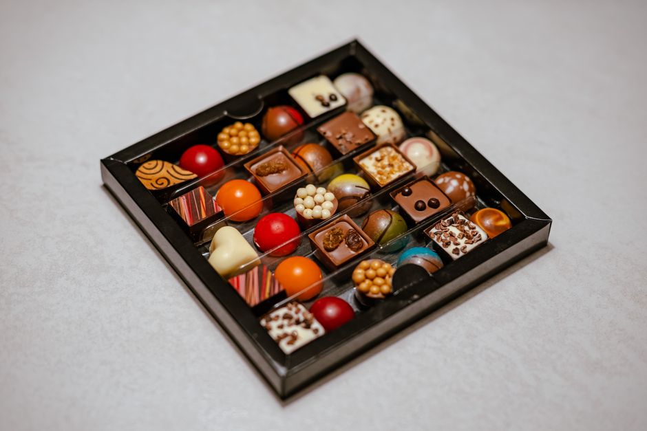 A delightful assortment of gourmet pralines and chocolates in a stylish box, perfect for gifting.